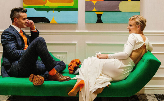 Couple on green couch at Kimpton Hotel Monaco Pittsburgh